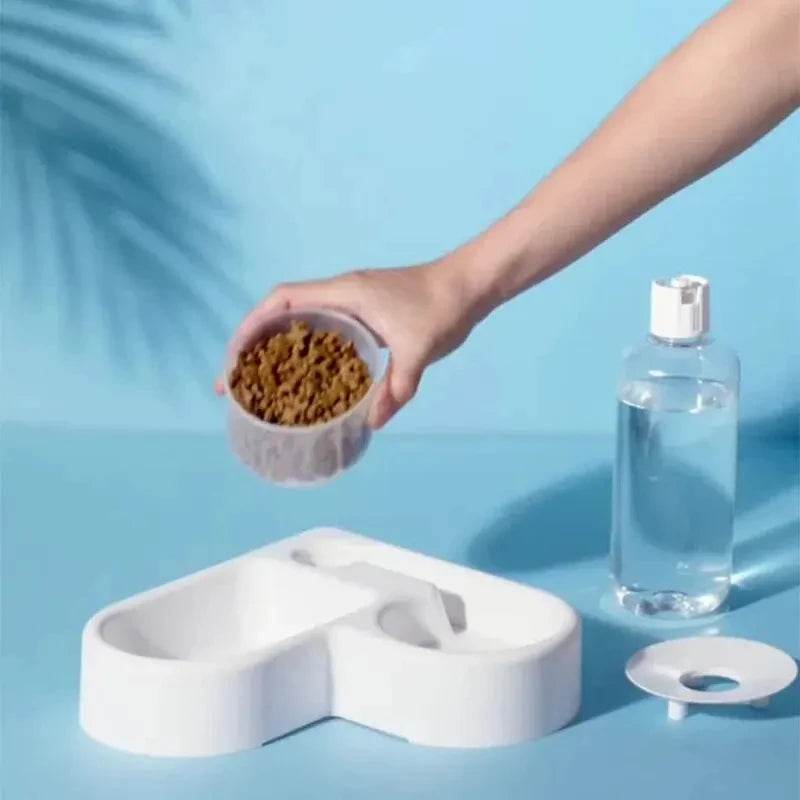 Fitzsi Essentials automatic cat dog feeder with a hand adding kibble and a water dispenser