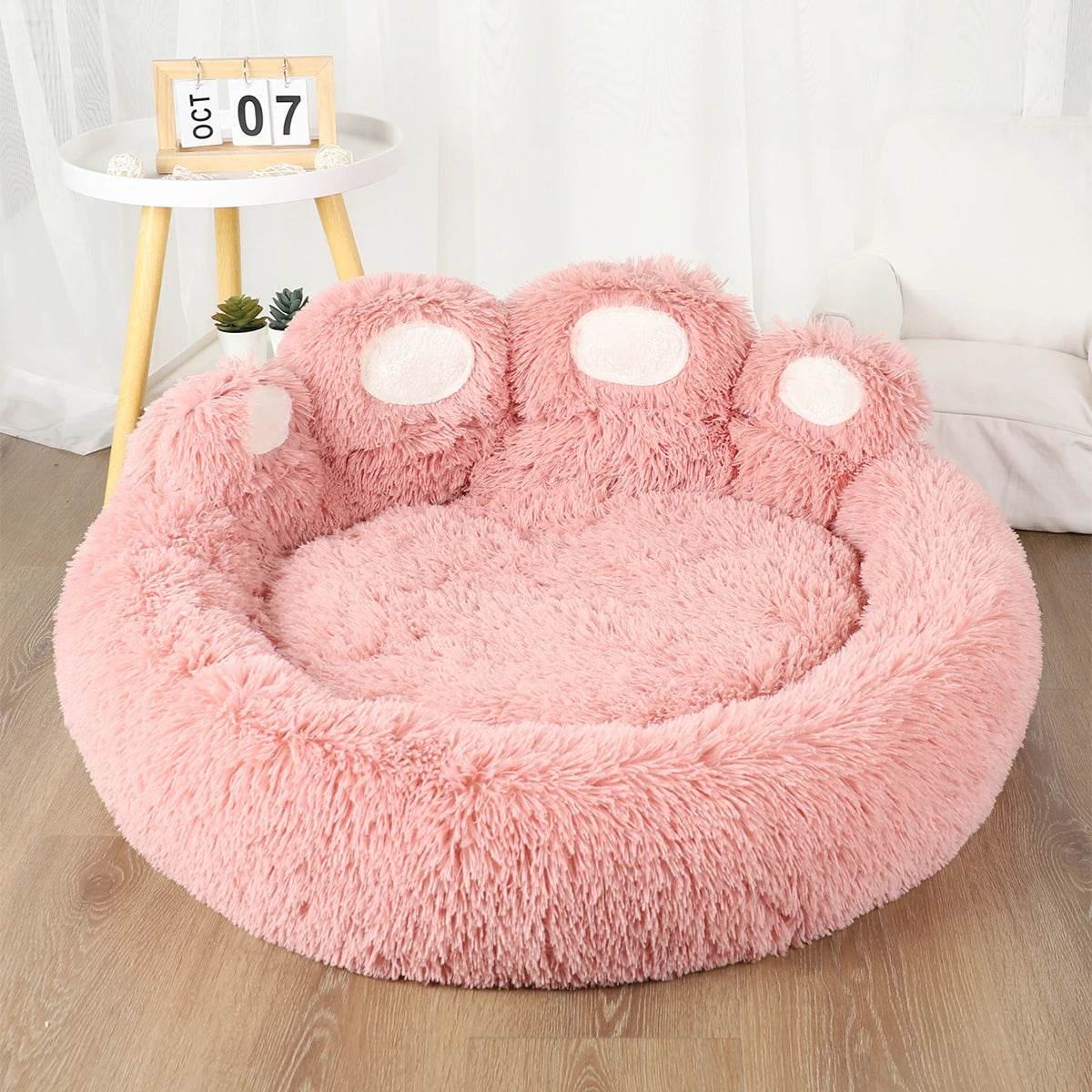 Large fluffy dog bed in pink with soft fabric and unique paw design for ultimate pet comfort