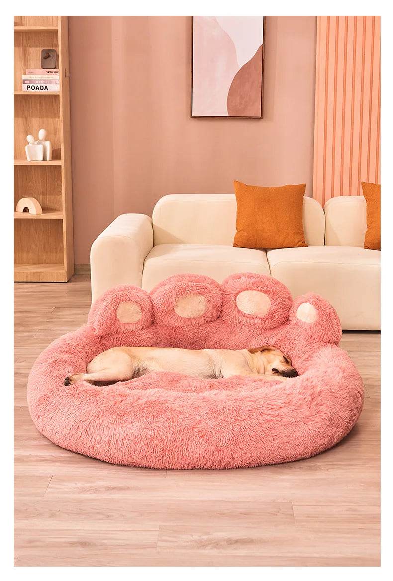 Large fluffy dog bed in pink color with supportive raised edges for ultimate comfort