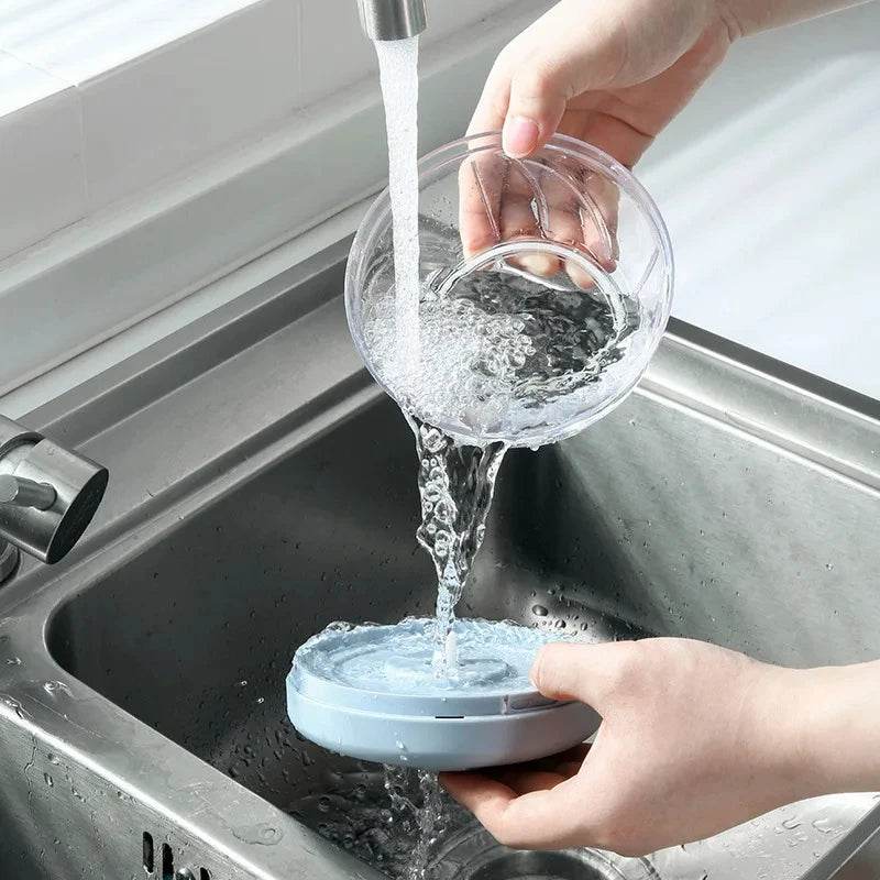Fitzsi Essentials meat and garlic mincer being rinsed in a sink for easy cleaning