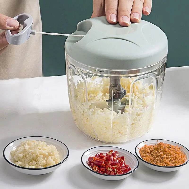 Fitzsi Essentials meat and garlic mincer with chopped ingredients in bowls, showing its easy-to-use design