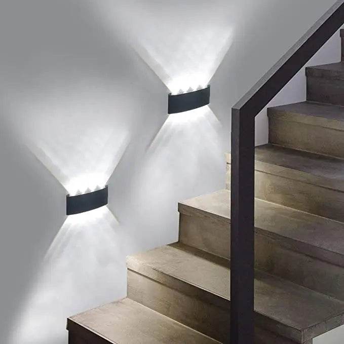 Modern LED wall sconces illuminating a stylish staircase with a sleek design and soft lighting