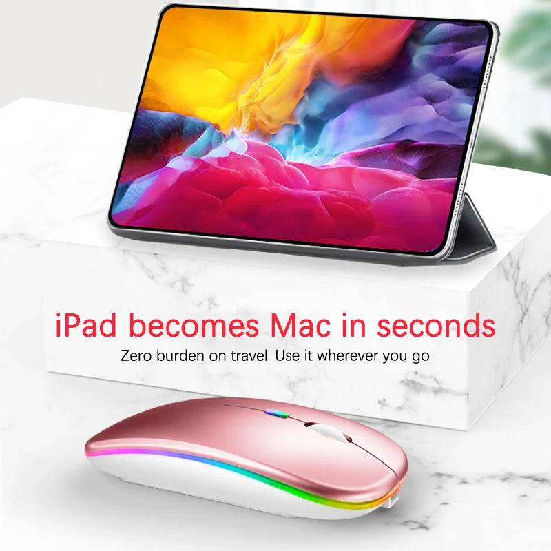 Fitzsi Essentials rechargeable Bluetooth wireless mouse in pink beside an iPad for easy use on the go