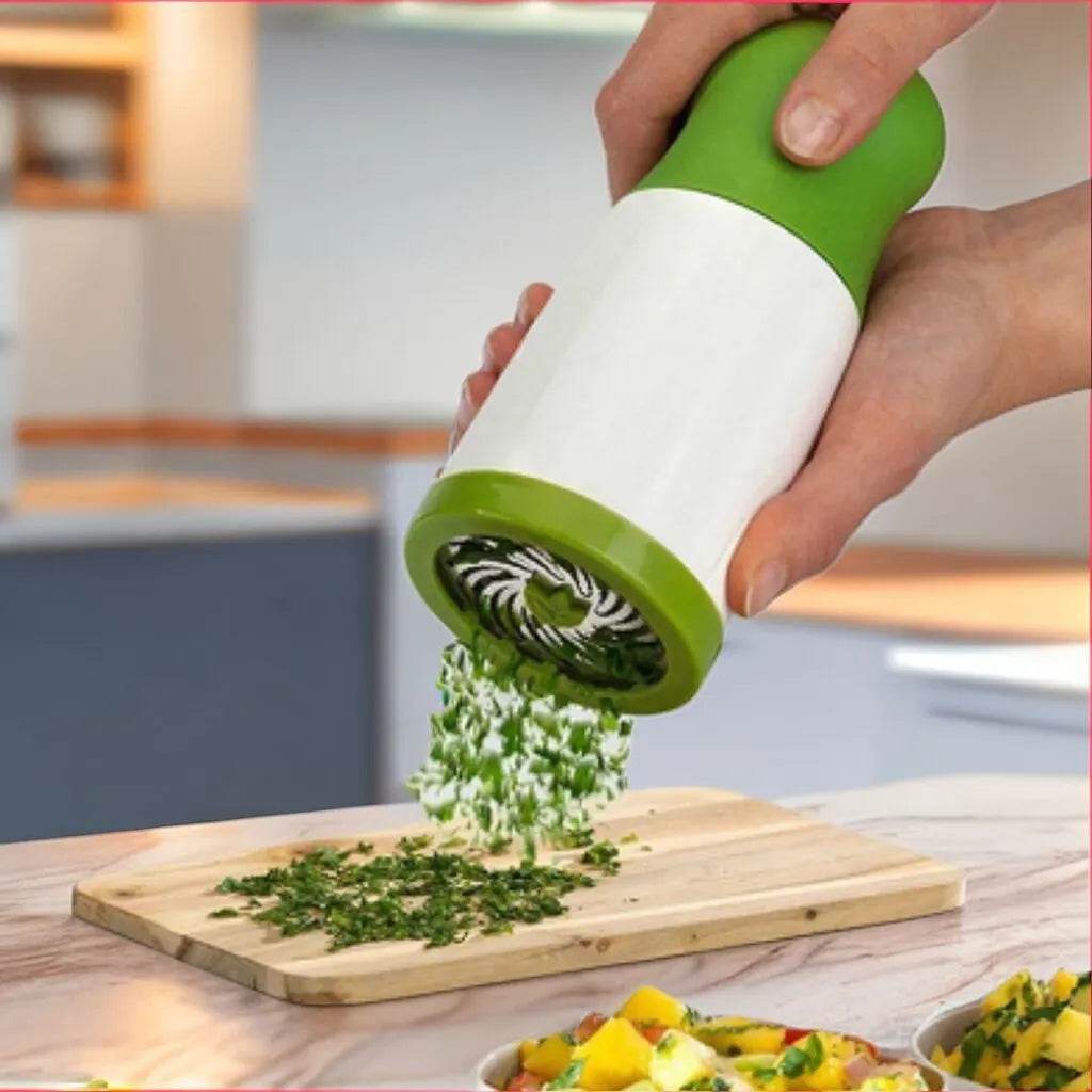 Fitzsi Essentials stainless steel spice grinder in action, finely grinding herbs on a cutting board