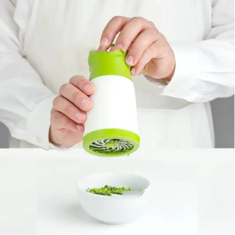 Fitzsi Essentials stainless steel spice grinder being used to finely grind herbs in a bowl