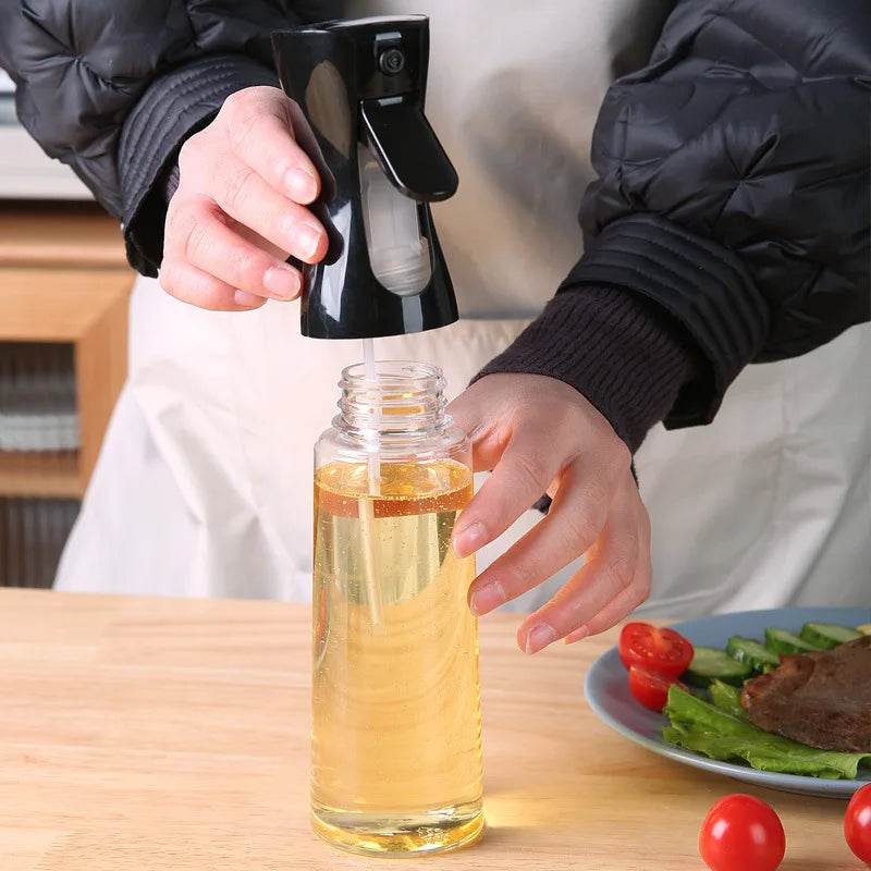 Hand using a stylish olive oil dispenser for BBQ to drizzle oil over grilled vegetables and meat