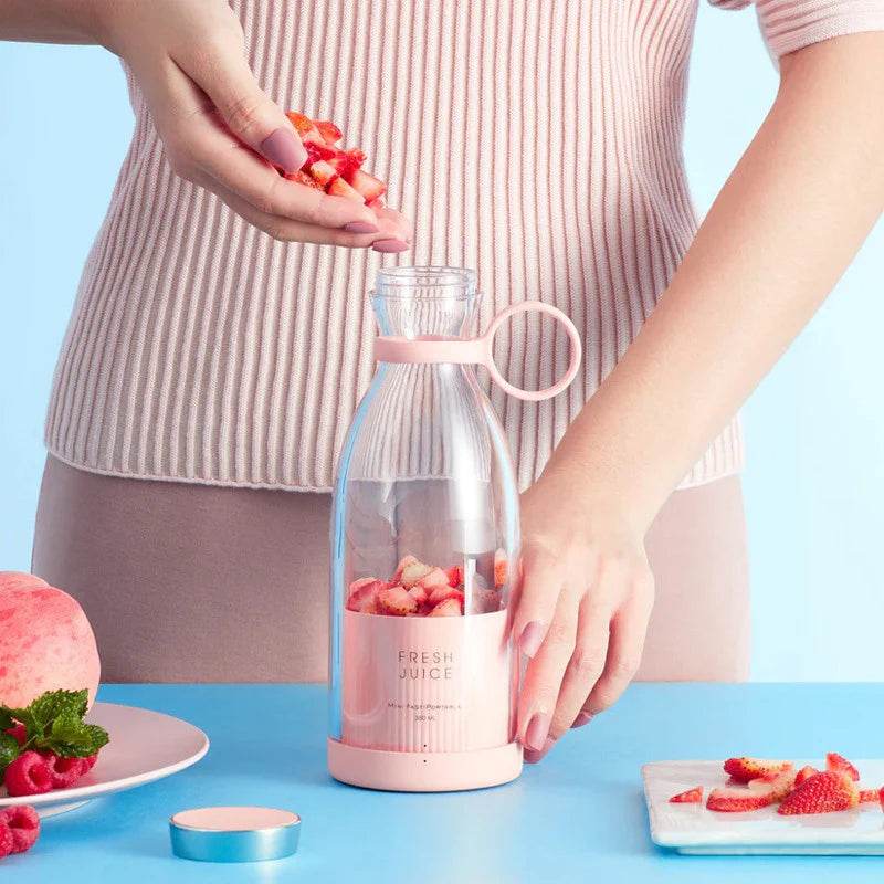 Person adding fruit to a Fitzsi Essentials portable fruit juicer bottle for fresh juice