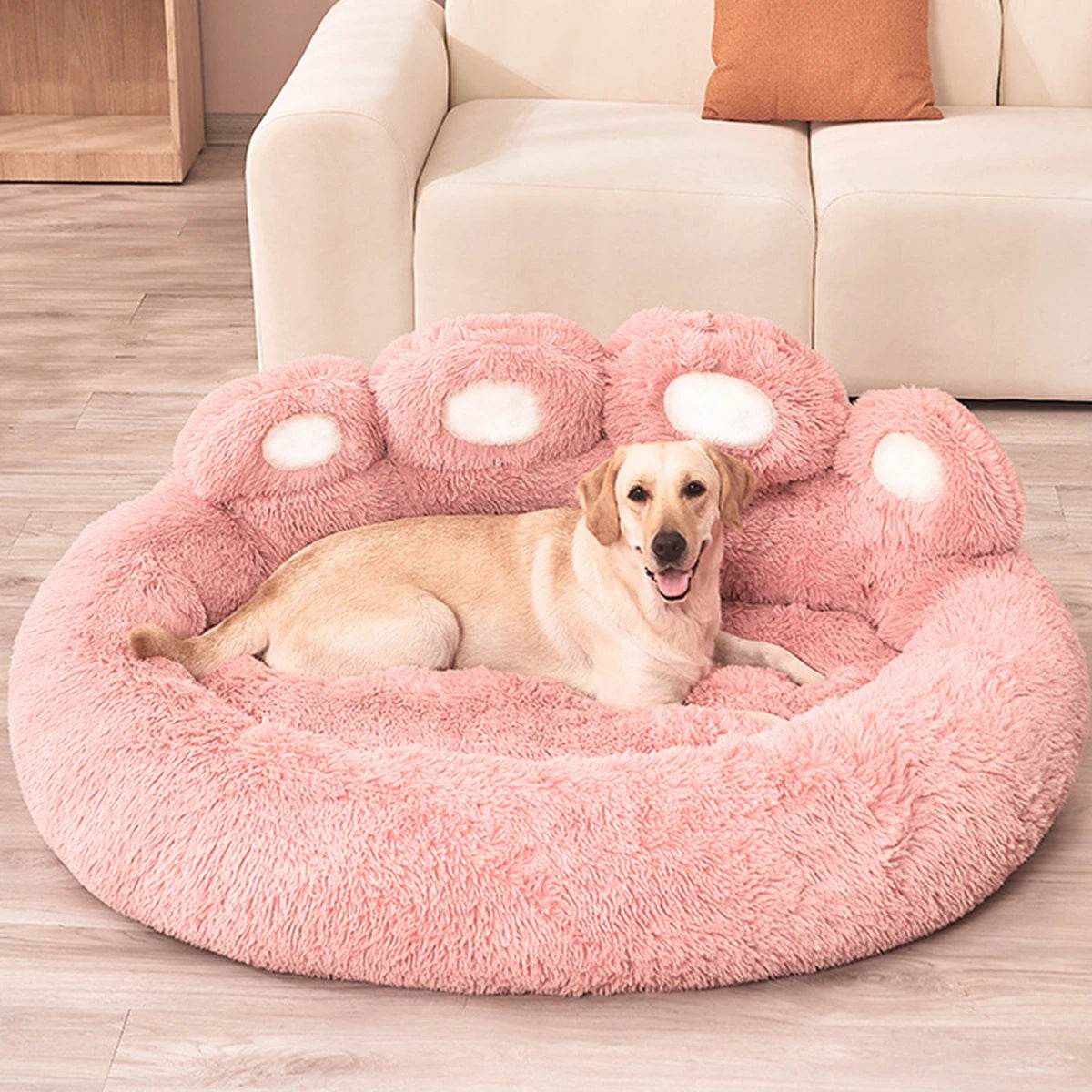 Large fluffy dog bed in pink with a comfortable design for pets to relax and sleep