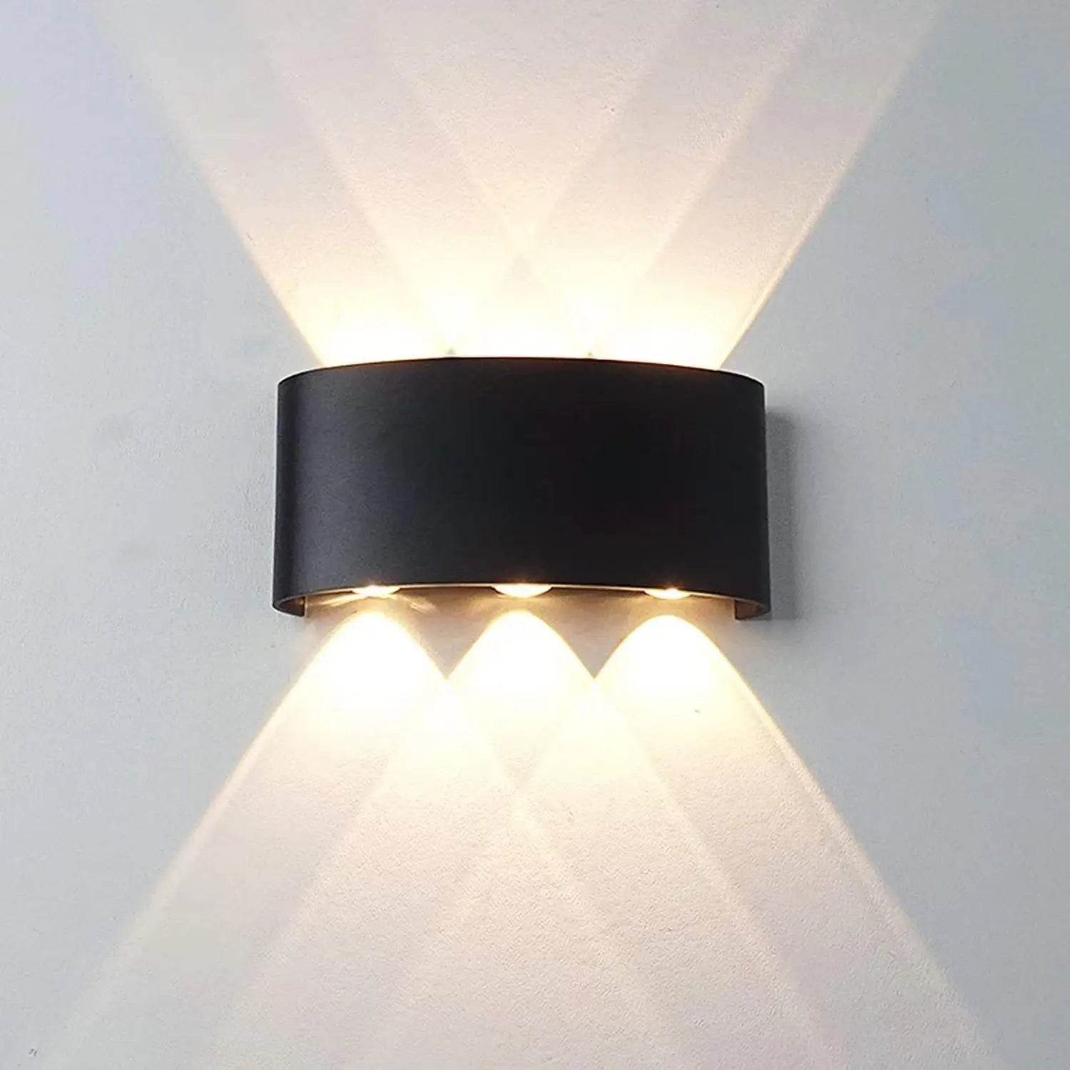 Stylish modern LED wall sconces with a curved black design and dual upward and downward lighting