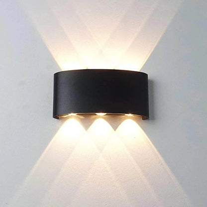 Stylish modern LED wall sconces with a curved black design and dual upward and downward lighting