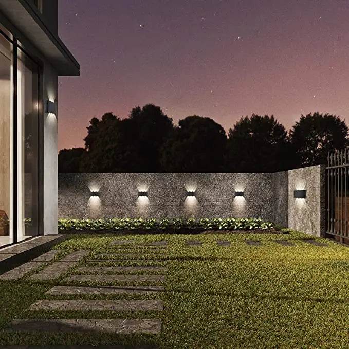 Modern LED wall sconces illuminating a landscaped outdoor area with a stylish design